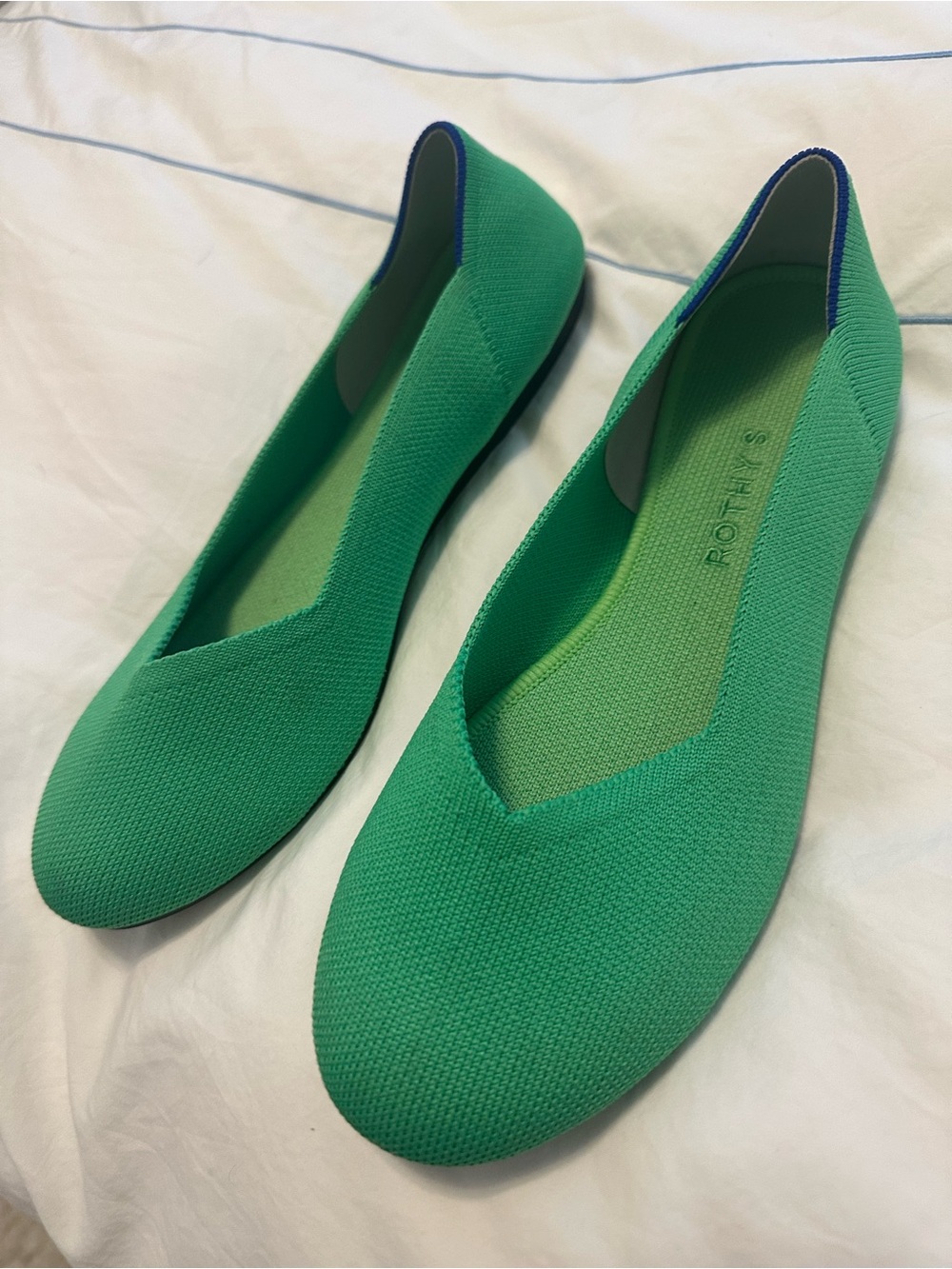Rothy’s Rare bright green flats with pink heel stripe